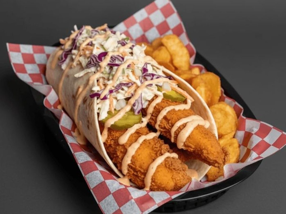 Spicy Slaw Wrap with chips in a checked paper basket